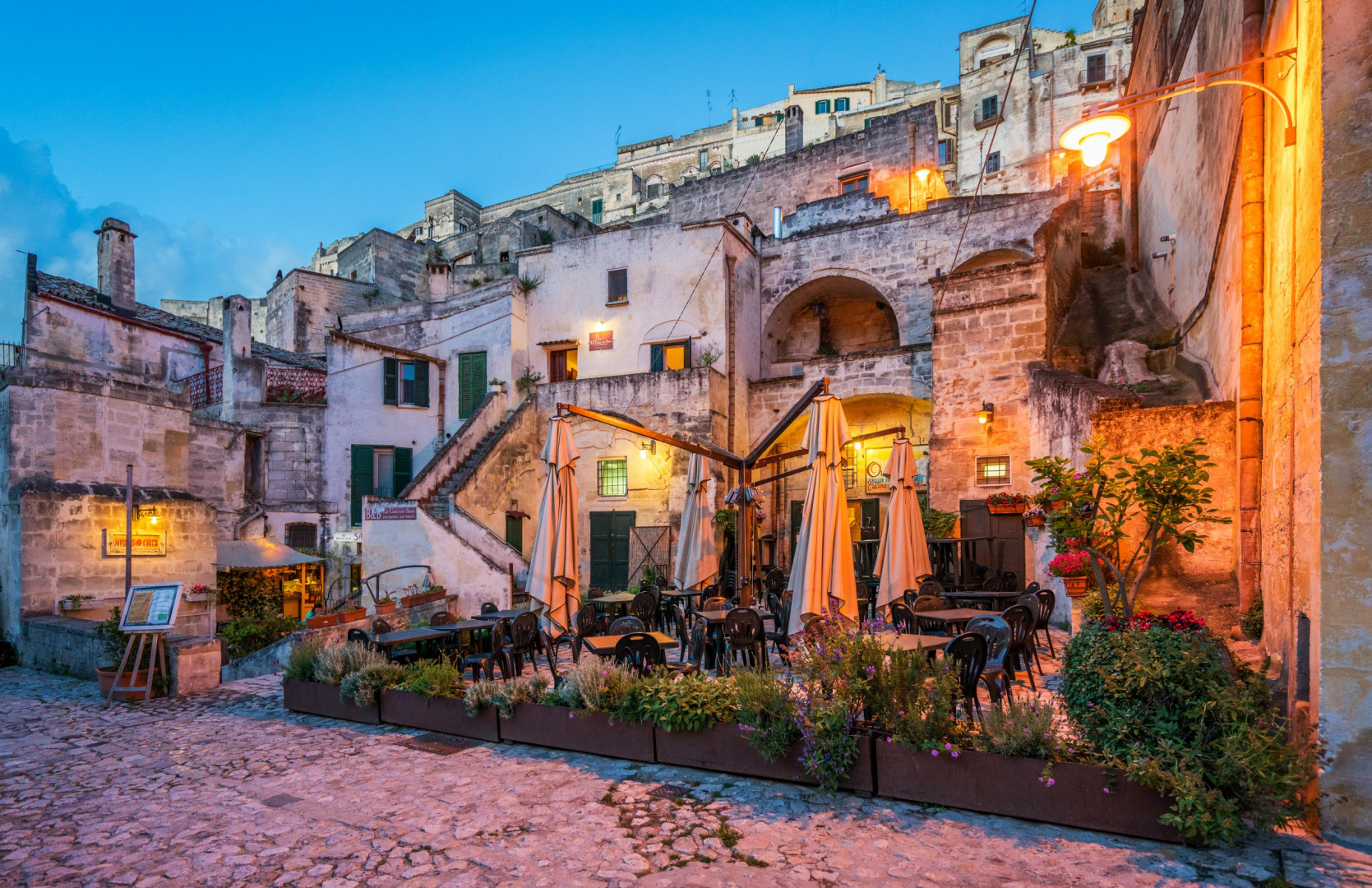 Charming outdoor dining scene in the historic Sassi districts of Matera.