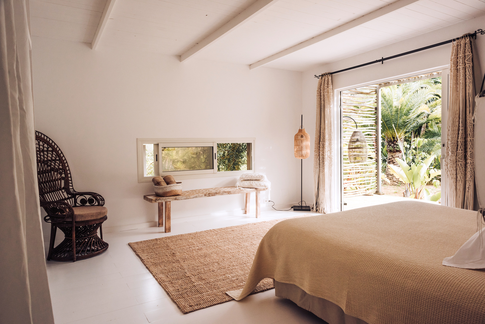 White walls and a coir rug in a guest room at Pure House Ibiza, one of the best hotels in Ibiza